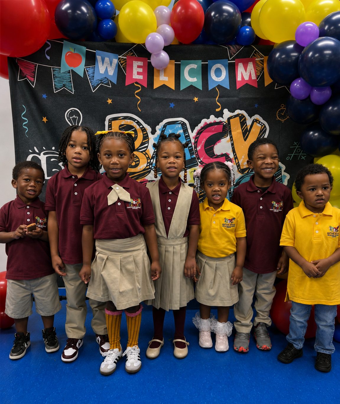 Gifted Minds students in uniform in front of a Welcome Back banner